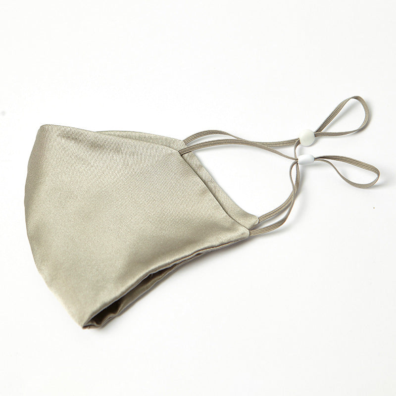 Champagne silk face mask with pleated front and beige drawstring ties