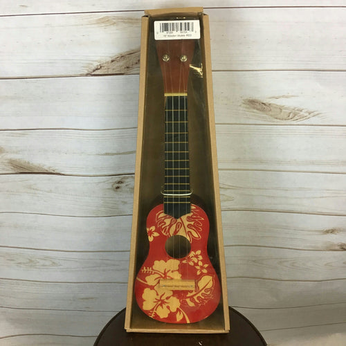 Wooden ukulele with red floral Hawaiian print, in open cardboard display box