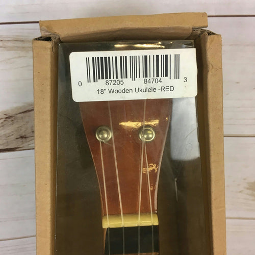 Boxed ukulele with barcode label, showing headstock and strings through window