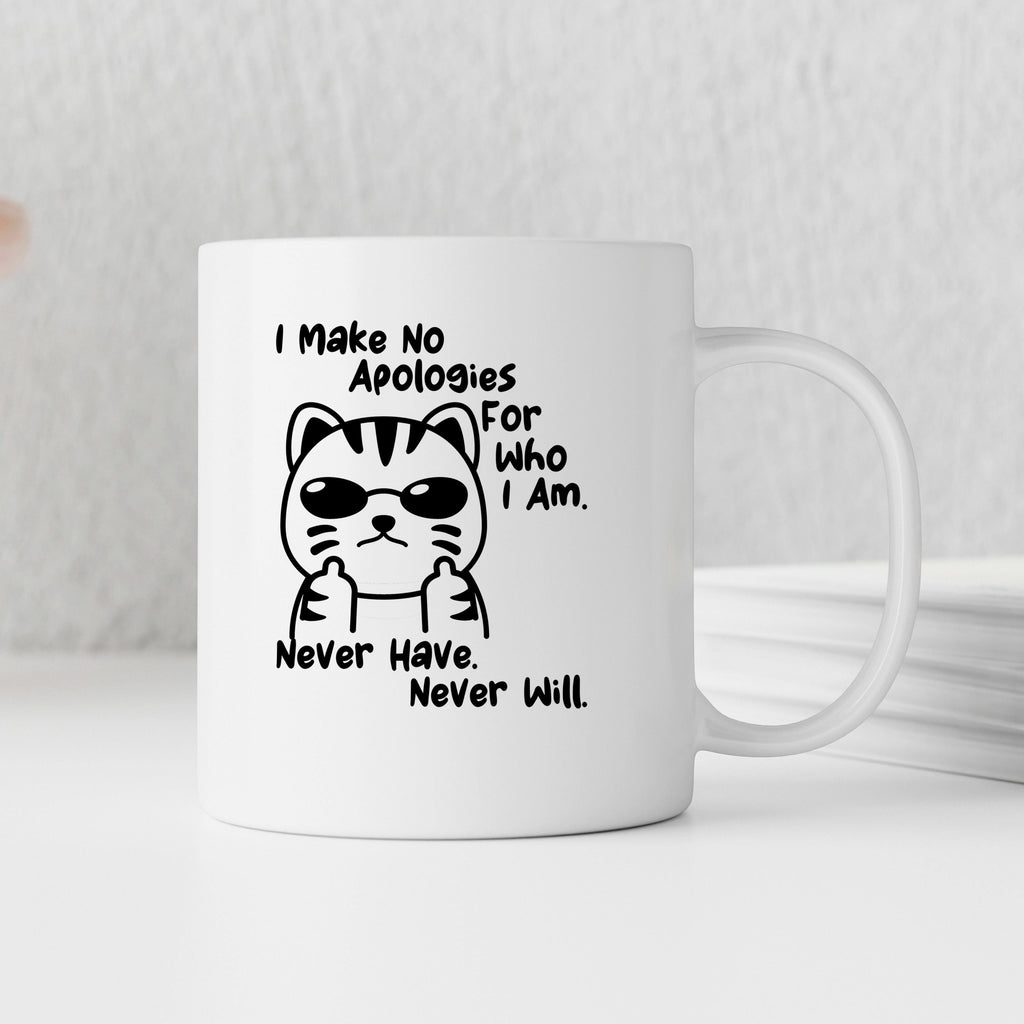 White ceramic coffee mug with black cat graphic and quote “I Make No Apologies for Who I Am.”