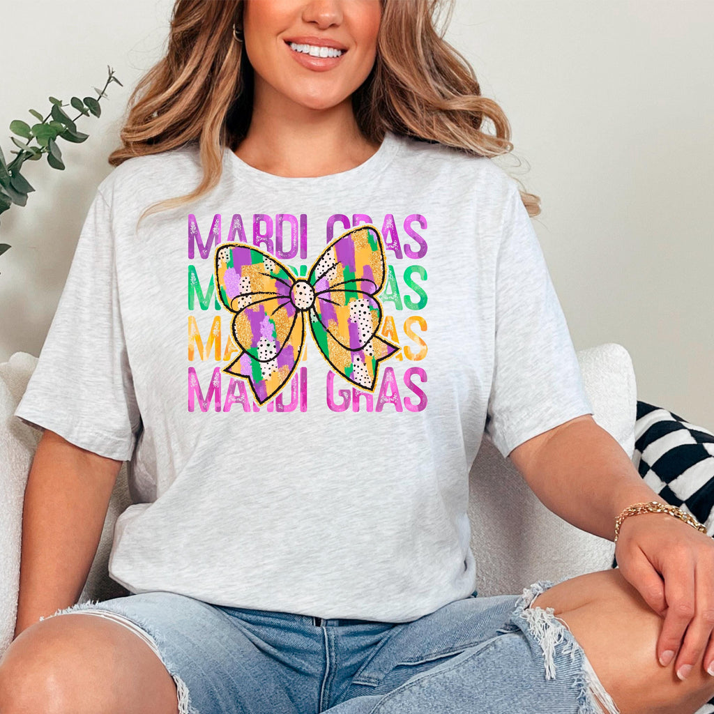 Heather gray t-shirt with Mardi Gras bow graphic, front knotted hem on model