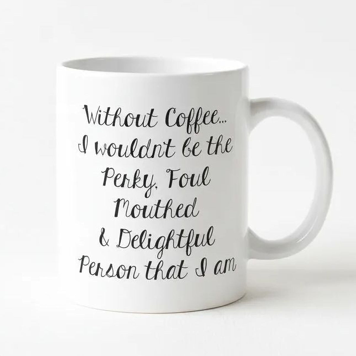 White ceramic coffee mug with black cursive quote: “Without Coffee... Perky, Foul...”