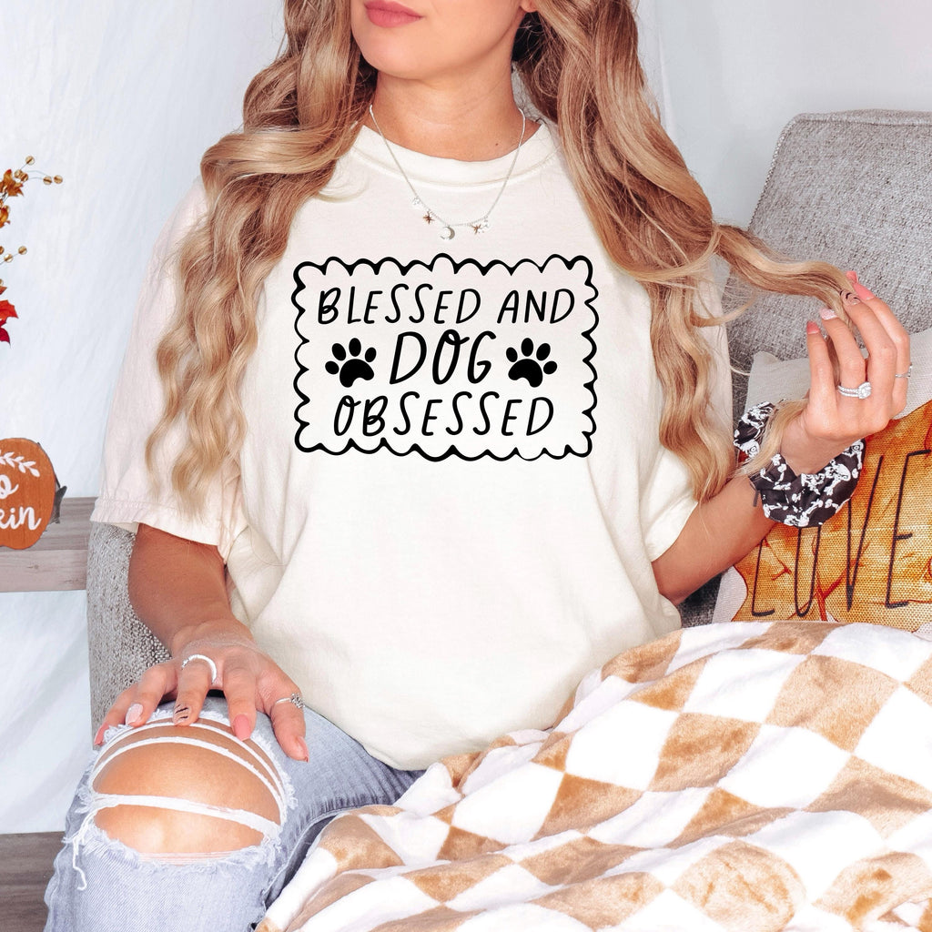 Ivory short-sleeve T-shirt with “Blessed and Dog Obsessed” paw print chest graphic