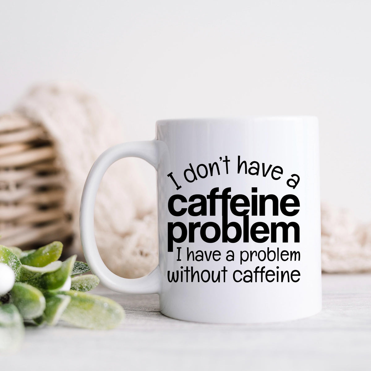 White ceramic mug with "I don't have a caffeine problem" quote in black lettering