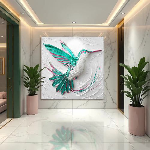 3D hummingbird wall art featuring a teal hummingbird with pink details on a white relief panel