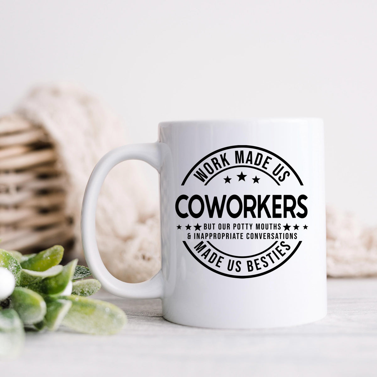 White coffee mug with black “COWORKERS” circular text design and handle