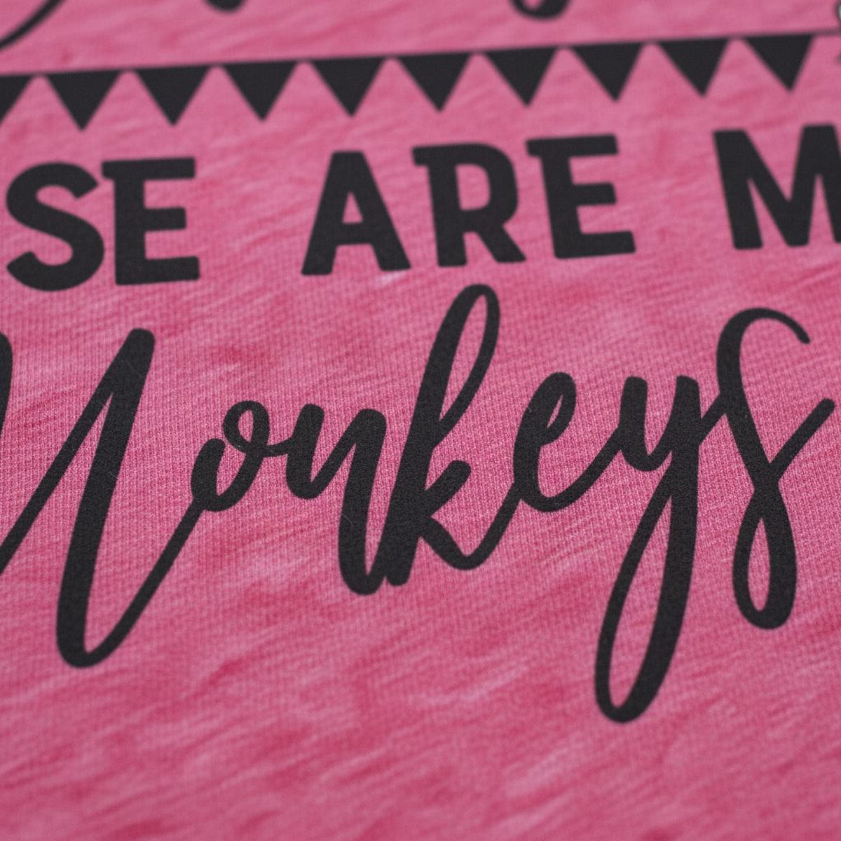Close-up of black text and monkey quote on pink T-shirt