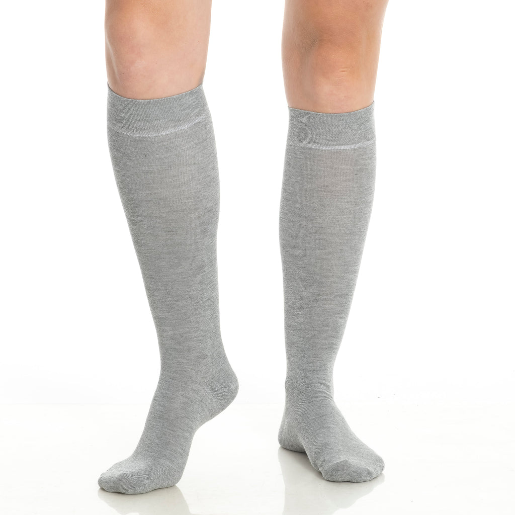 Close-up of gray knee-high socks on legs with soft cuff