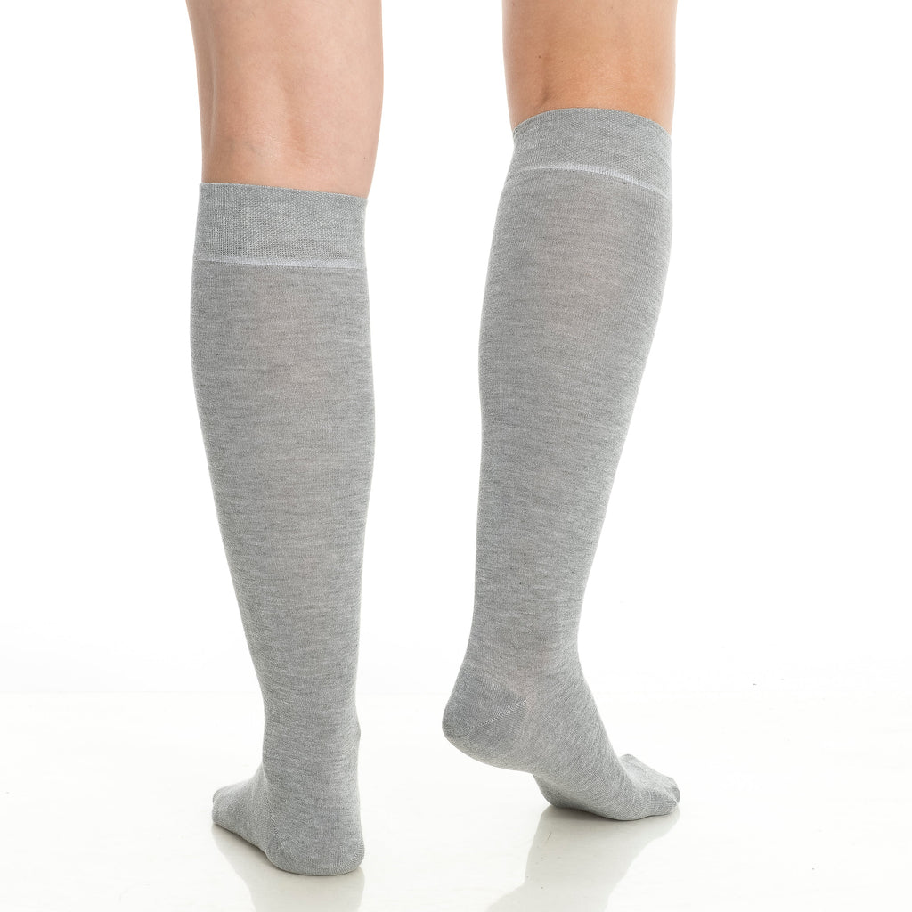 Two pairs of gray knee-high socks worn on legs