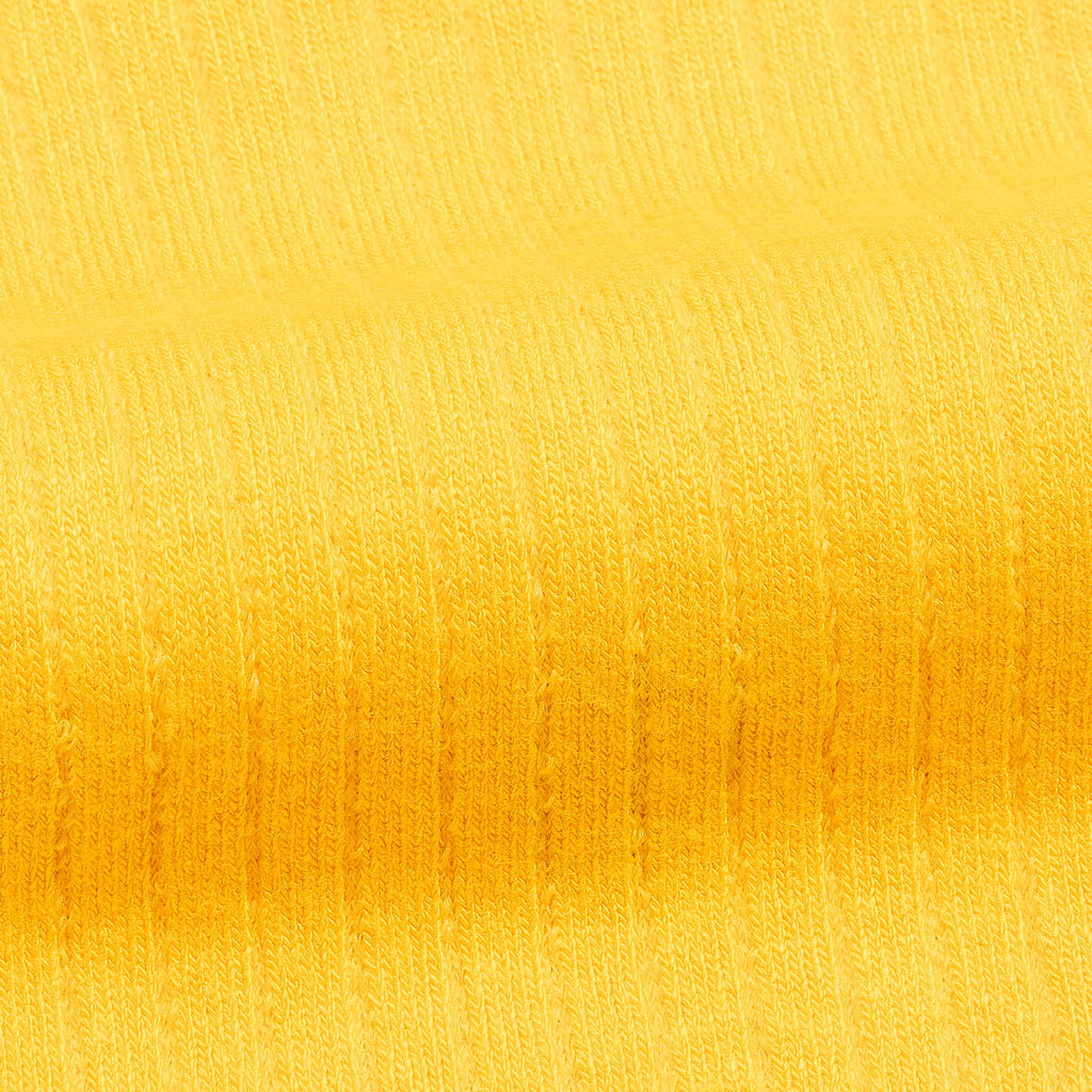Men's bamboo dress socks fabric, yellow knit texture close-up