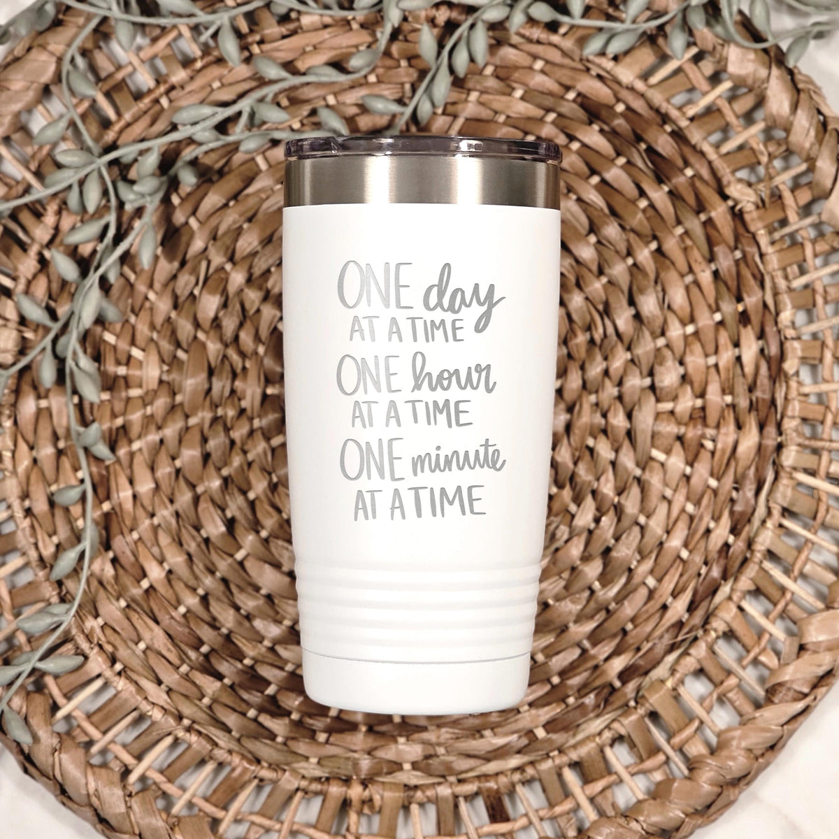 White stainless steel tumbler with “One day at a time” print
