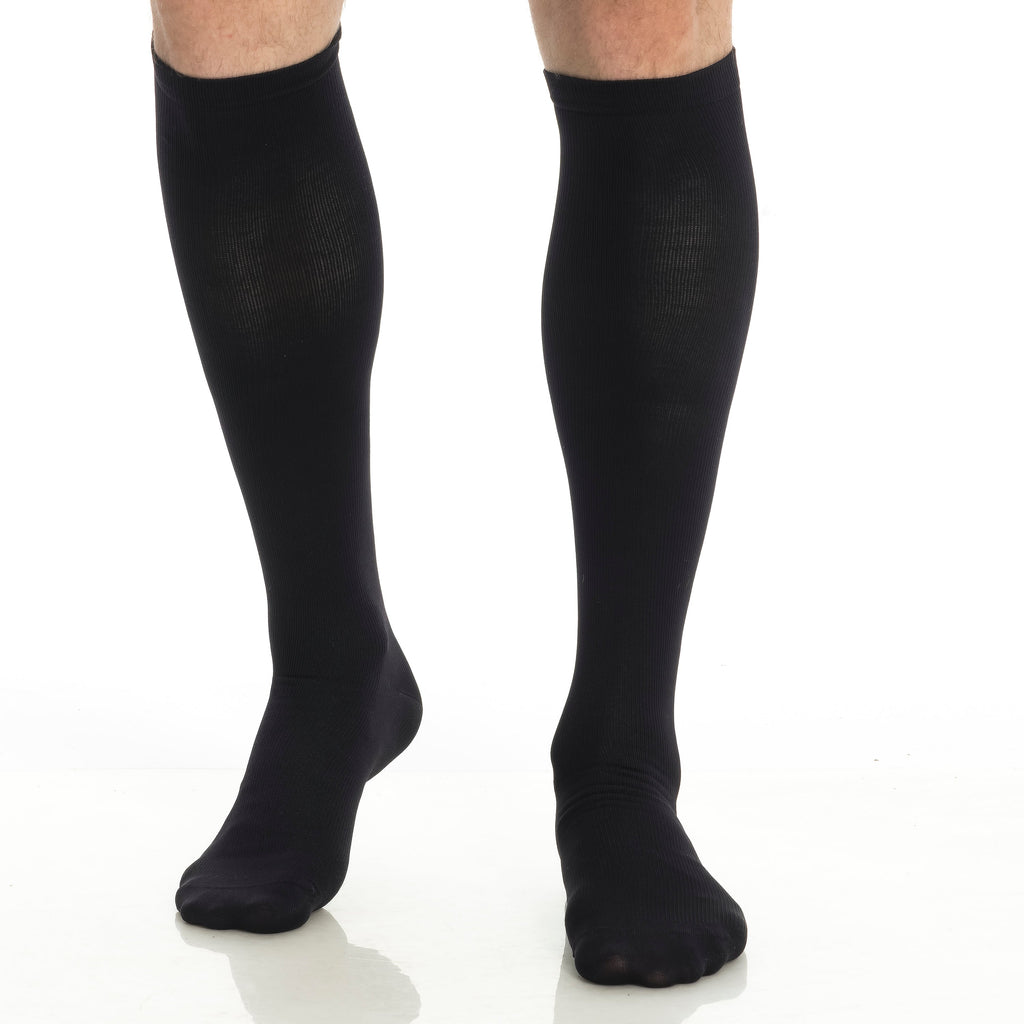 Black knee-high compression socks worn on two legs