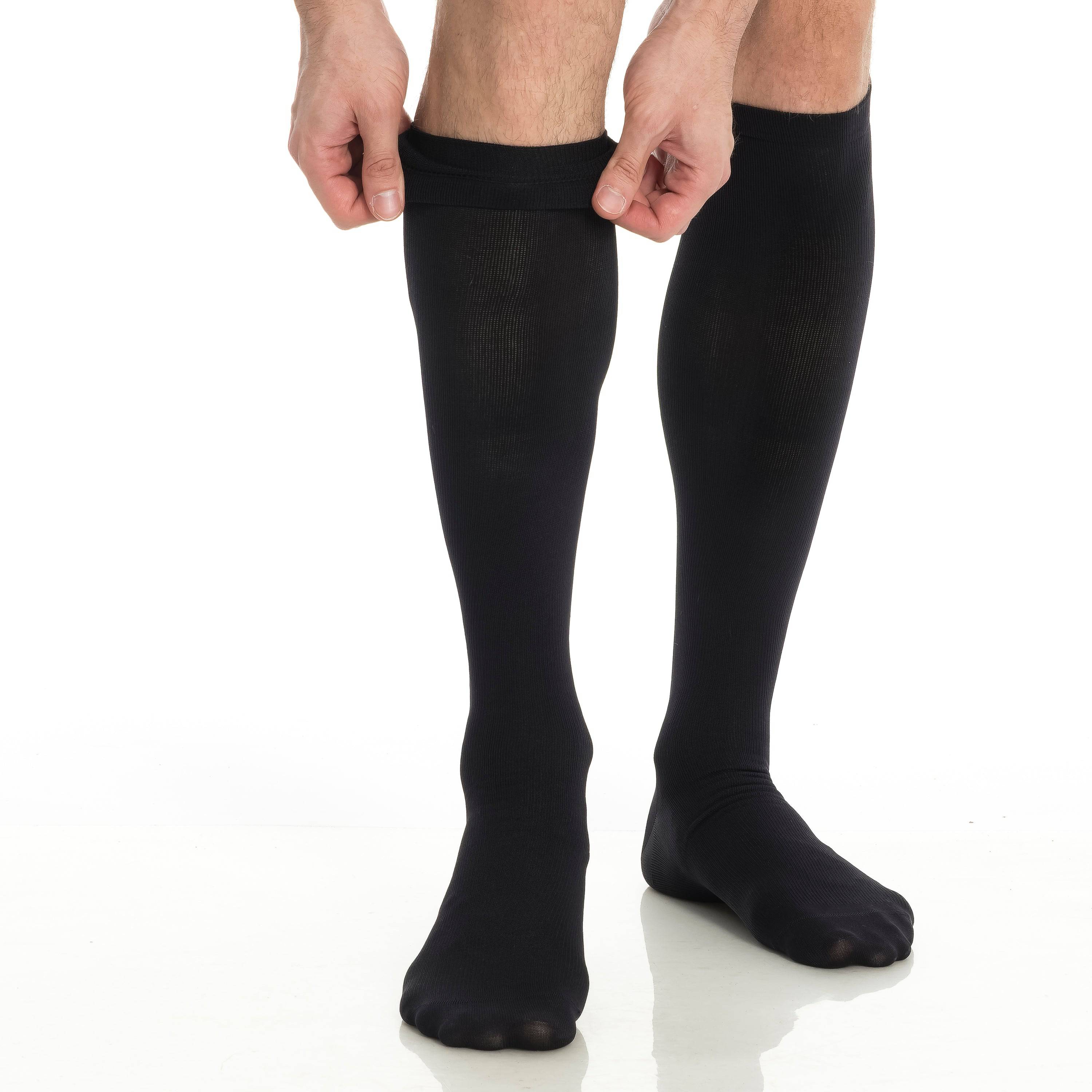 Black knee-high compression socks worn on two legs