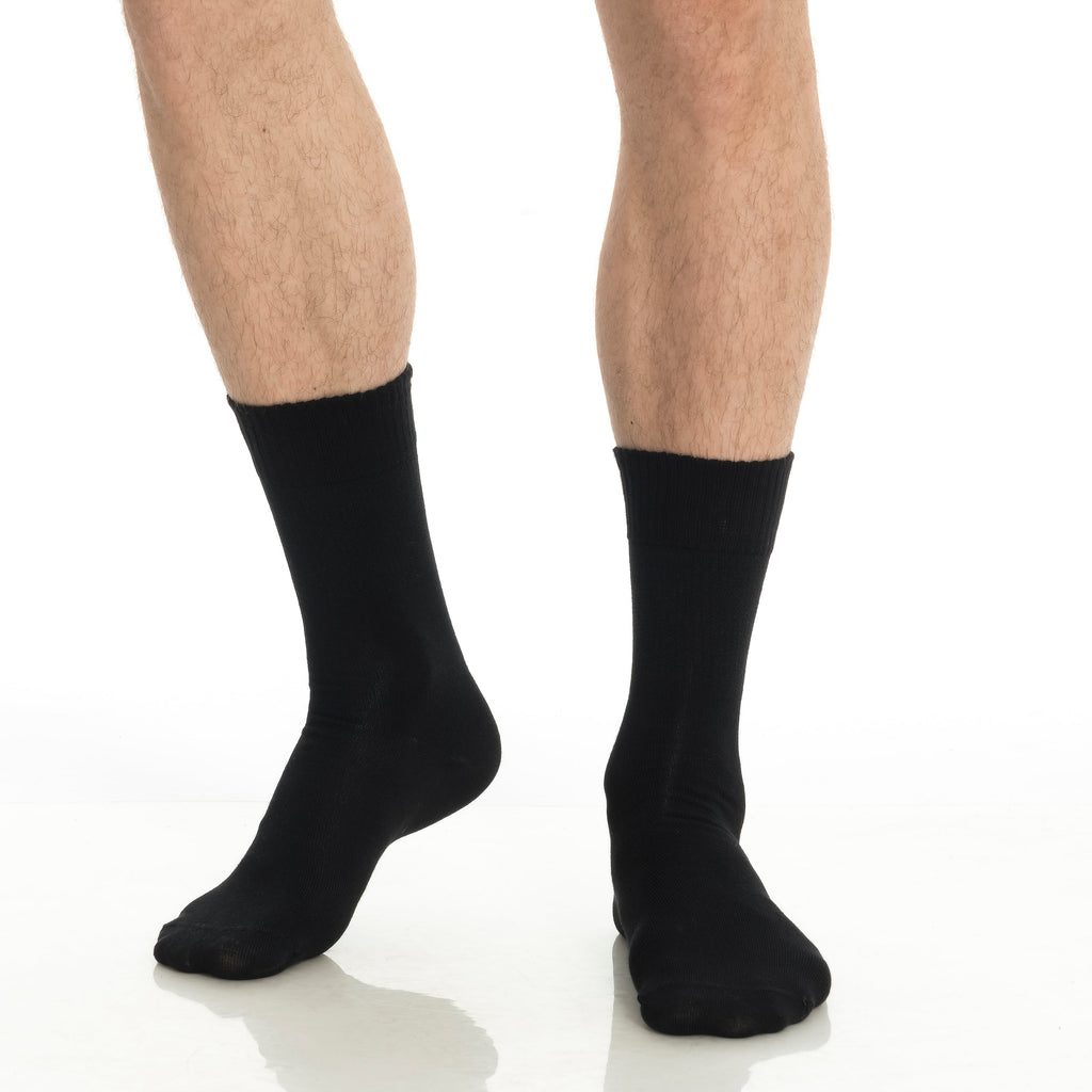 Black bamboo diabetic crew socks on feet, two legs wearing crew socks.