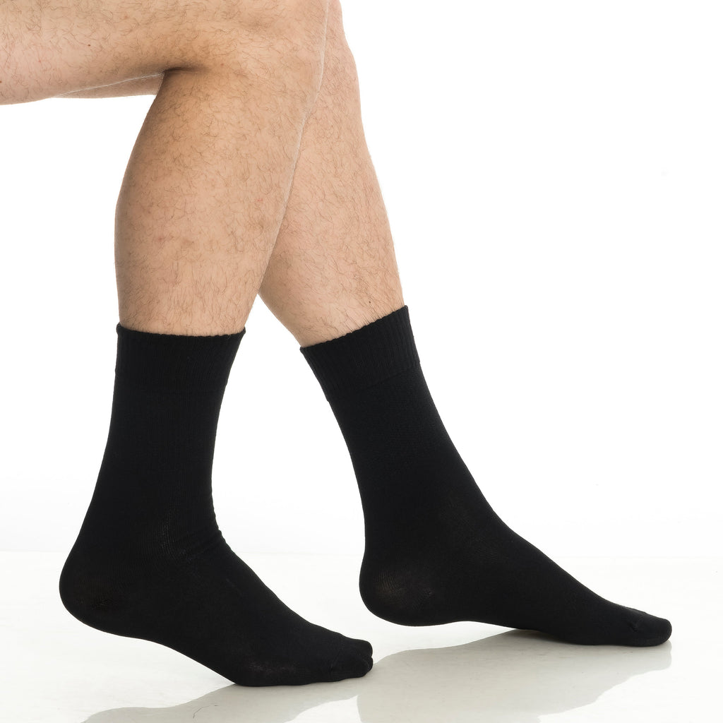 Black diabetic crew socks, two pairs shown on a person’s legs