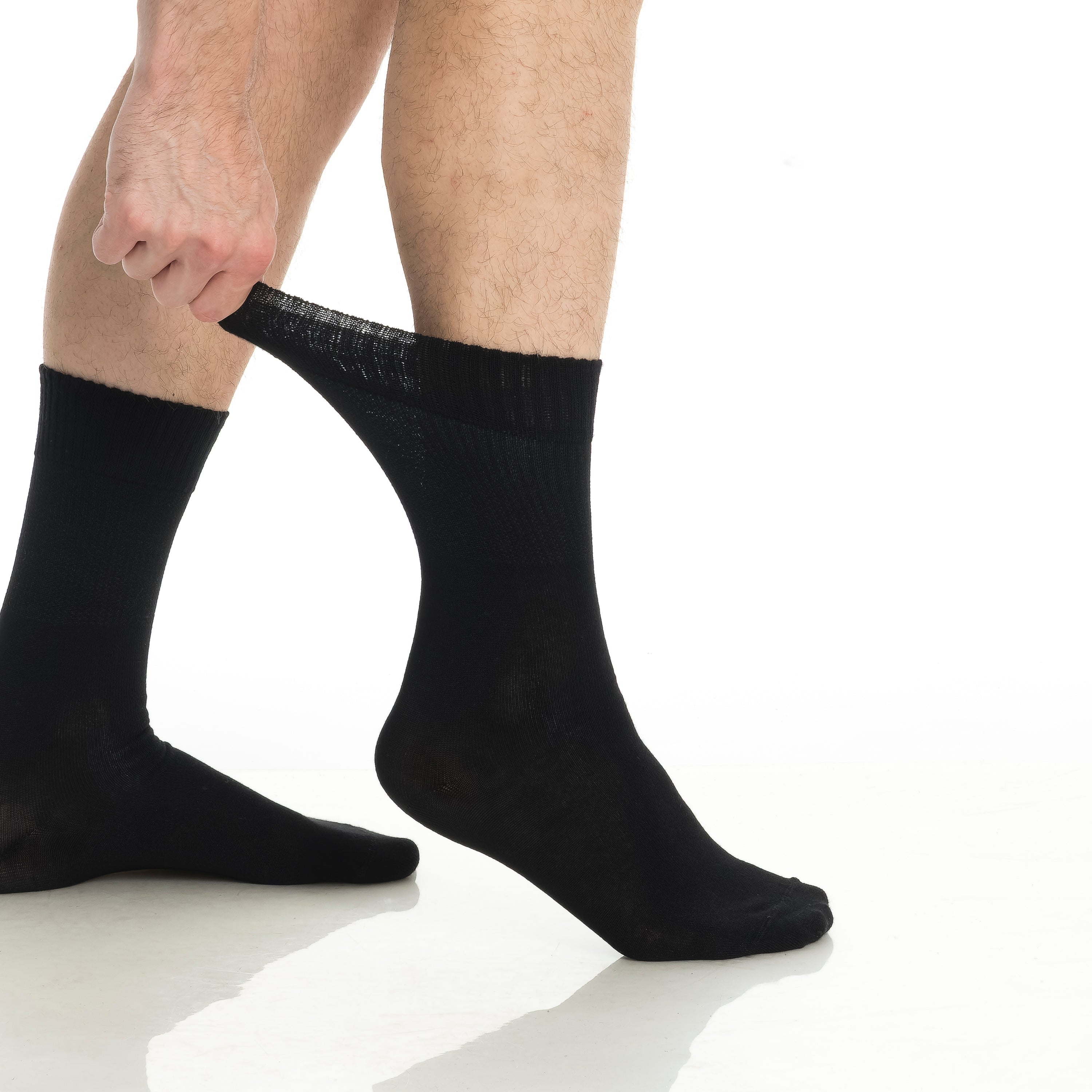 Black bamboo diabetic crew socks on feet, close-up showing crew cuff and sole.