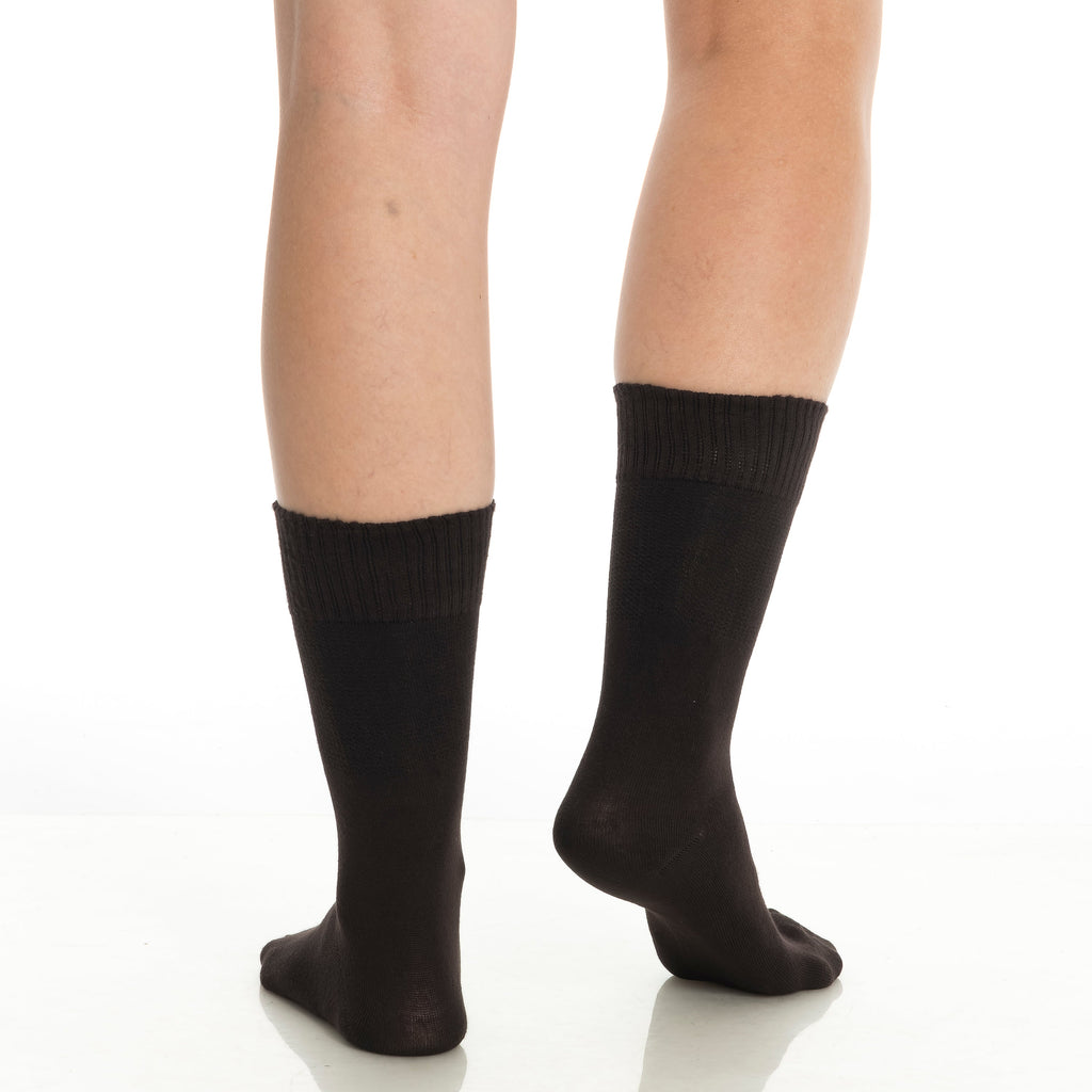 Black diabetic crew socks on two legs, close-up view