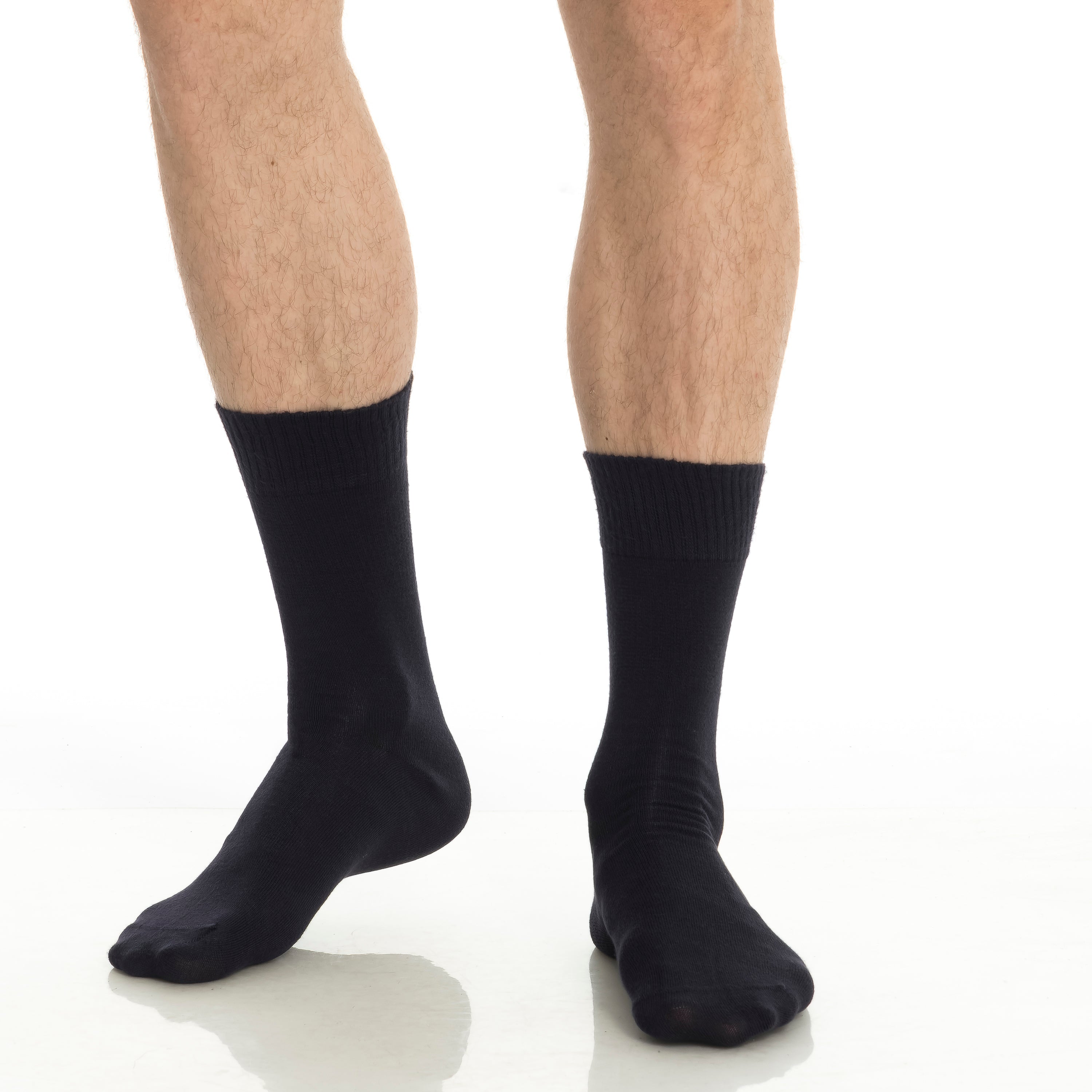 Black crew socks on model, mid-calf length, ribbed cuffs