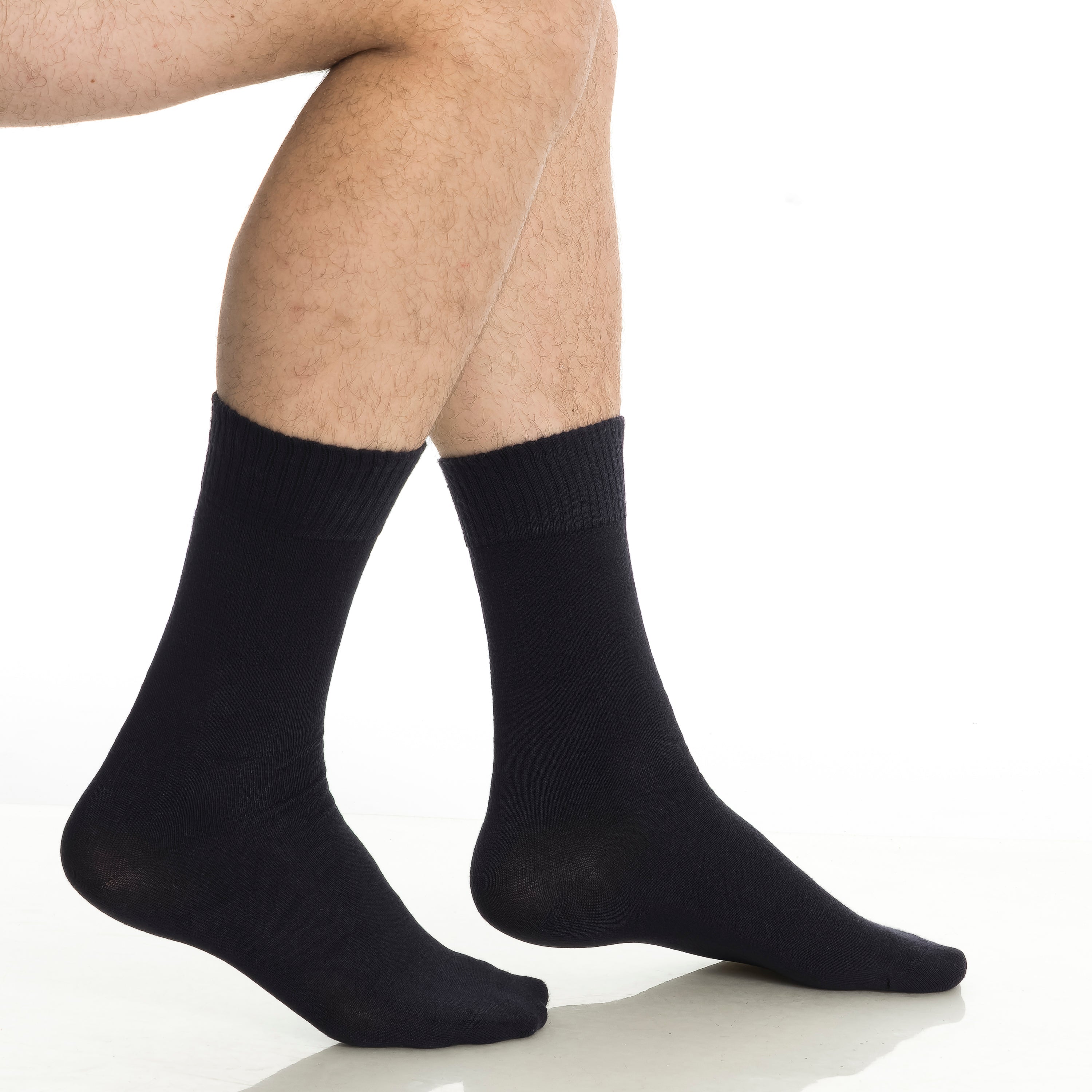 Black crew socks on feet, ribbed knit and cushioned sole