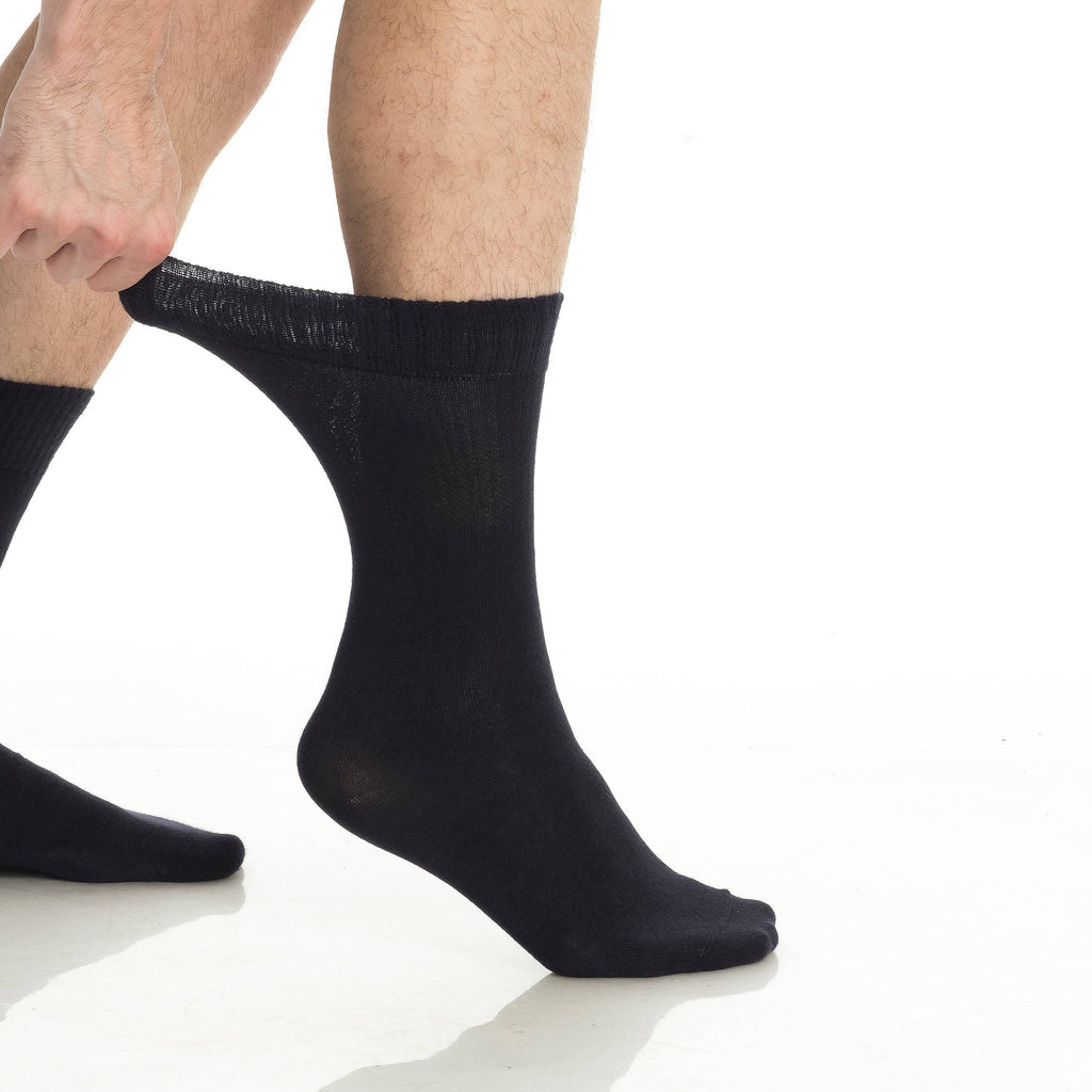Black crew socks on feet, ribbed cuff and smooth knit throughout the leg.