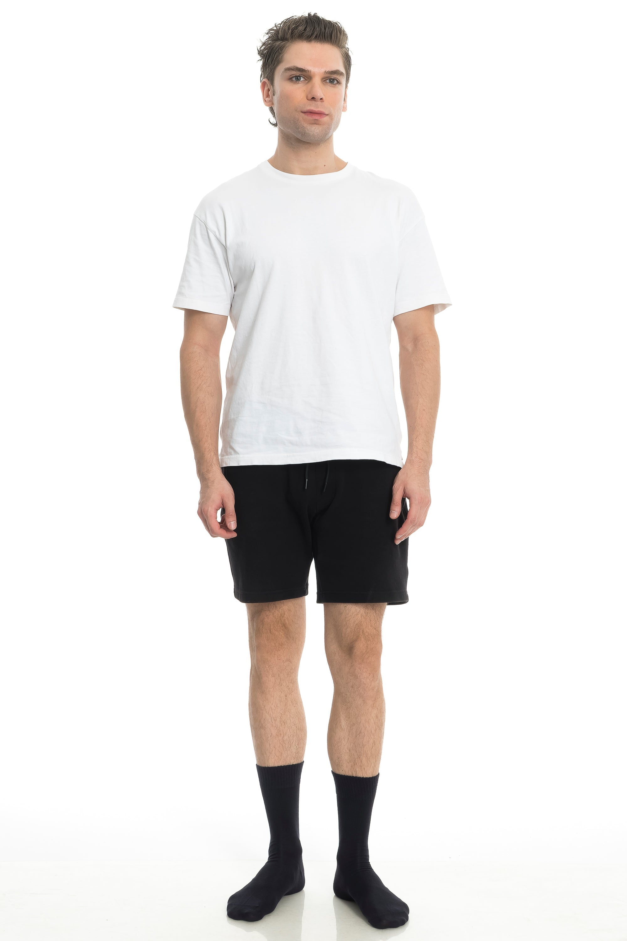 Black crew socks on model with shorts, ribbed mid-calf cuffs