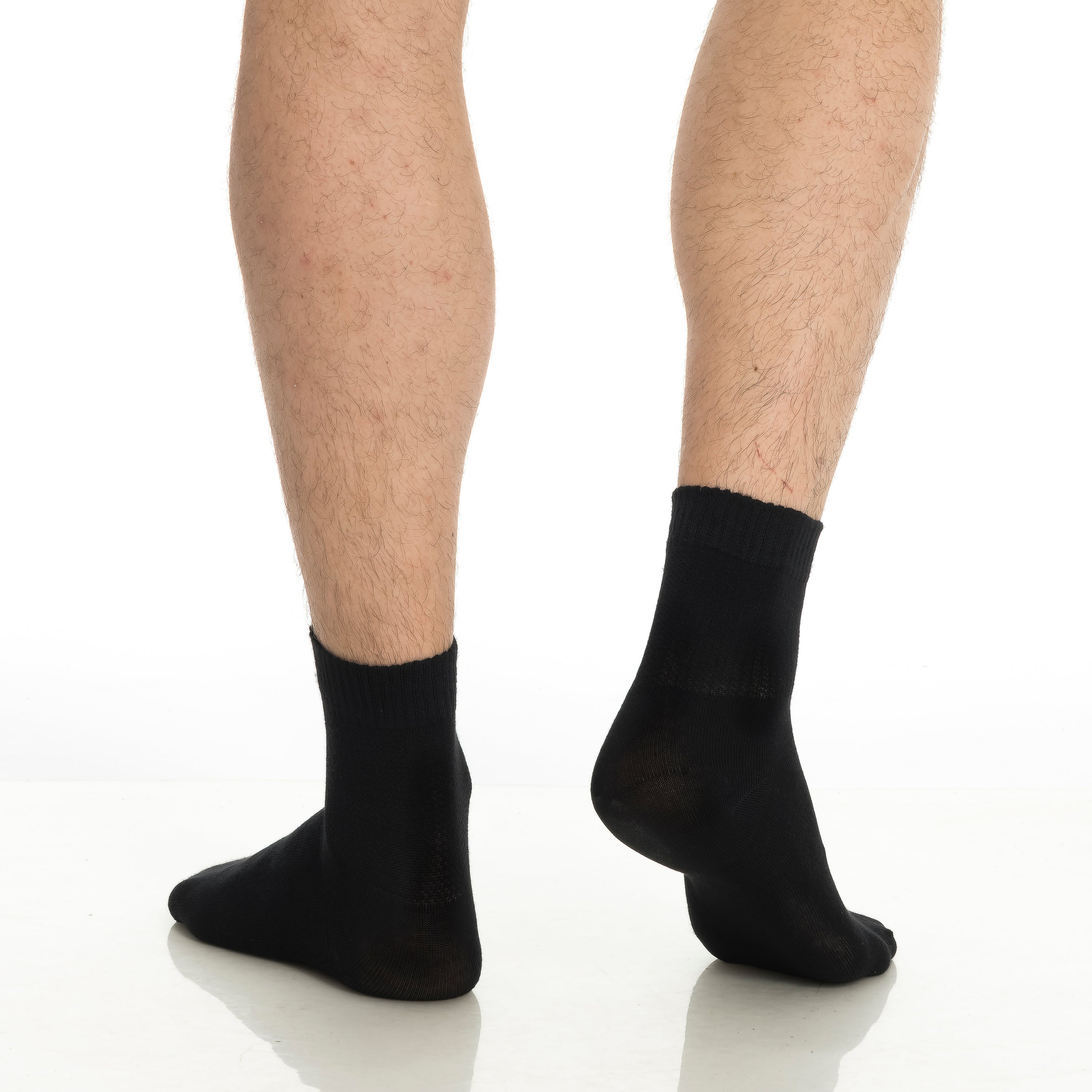 Black bamboo diabetic ankle socks on feet, ankle-length crew socks.