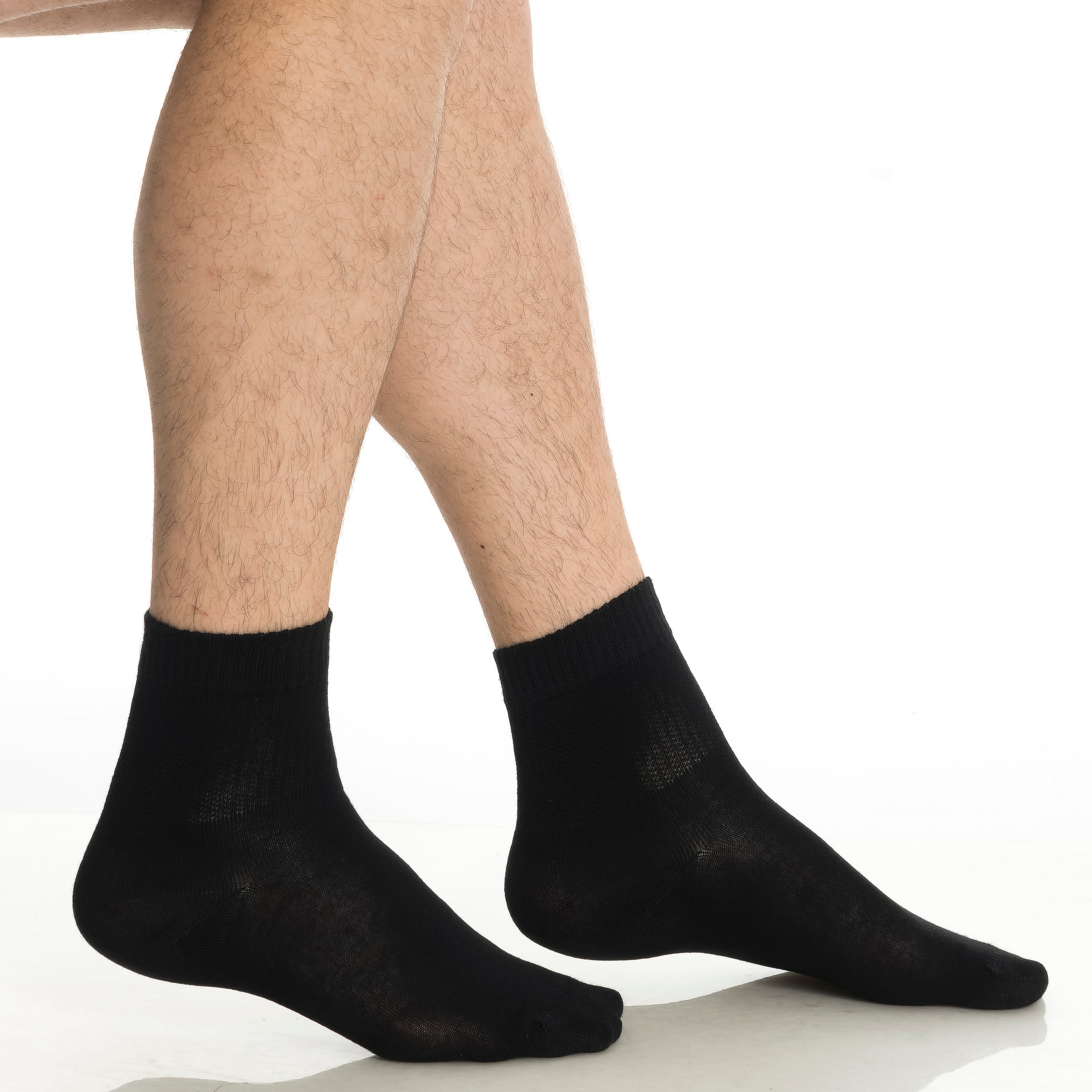 Black bamboo diabetic ankle socks on legs, ribbed crew cuff visible.