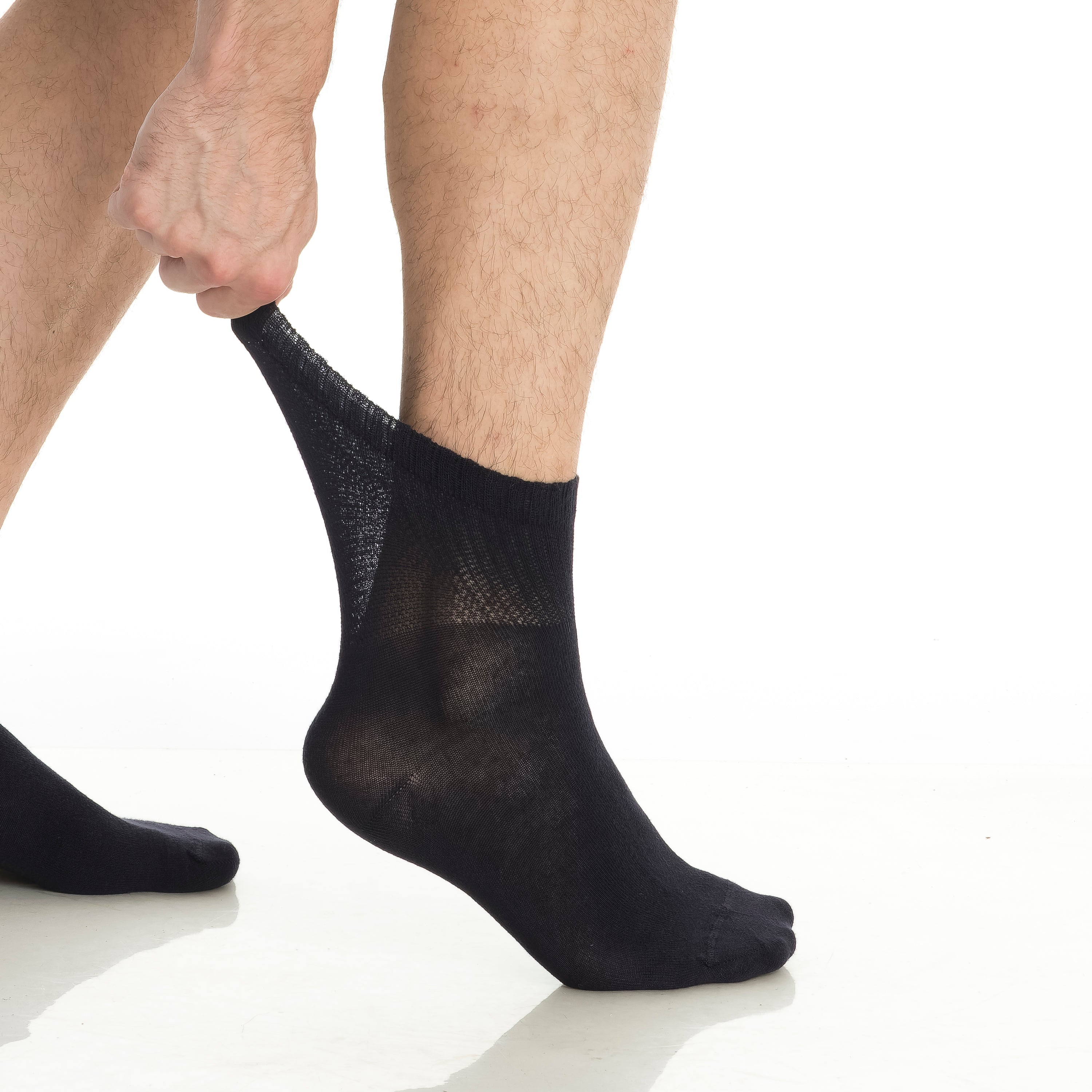 Bamboo diabetic ankle socks 4-pack, black sock on foot with visible stretch