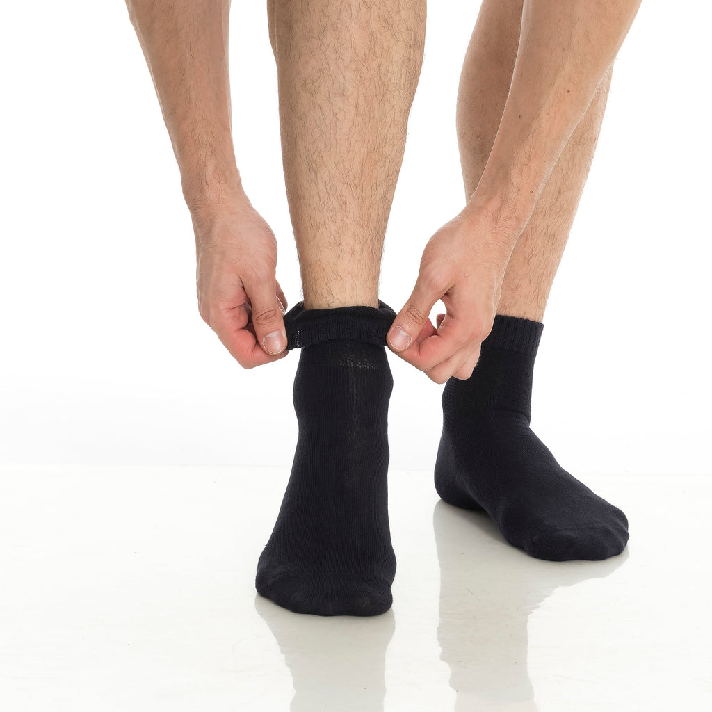 Bamboo diabetic ankle socks 4-pack, black socks being pulled on at the ankle