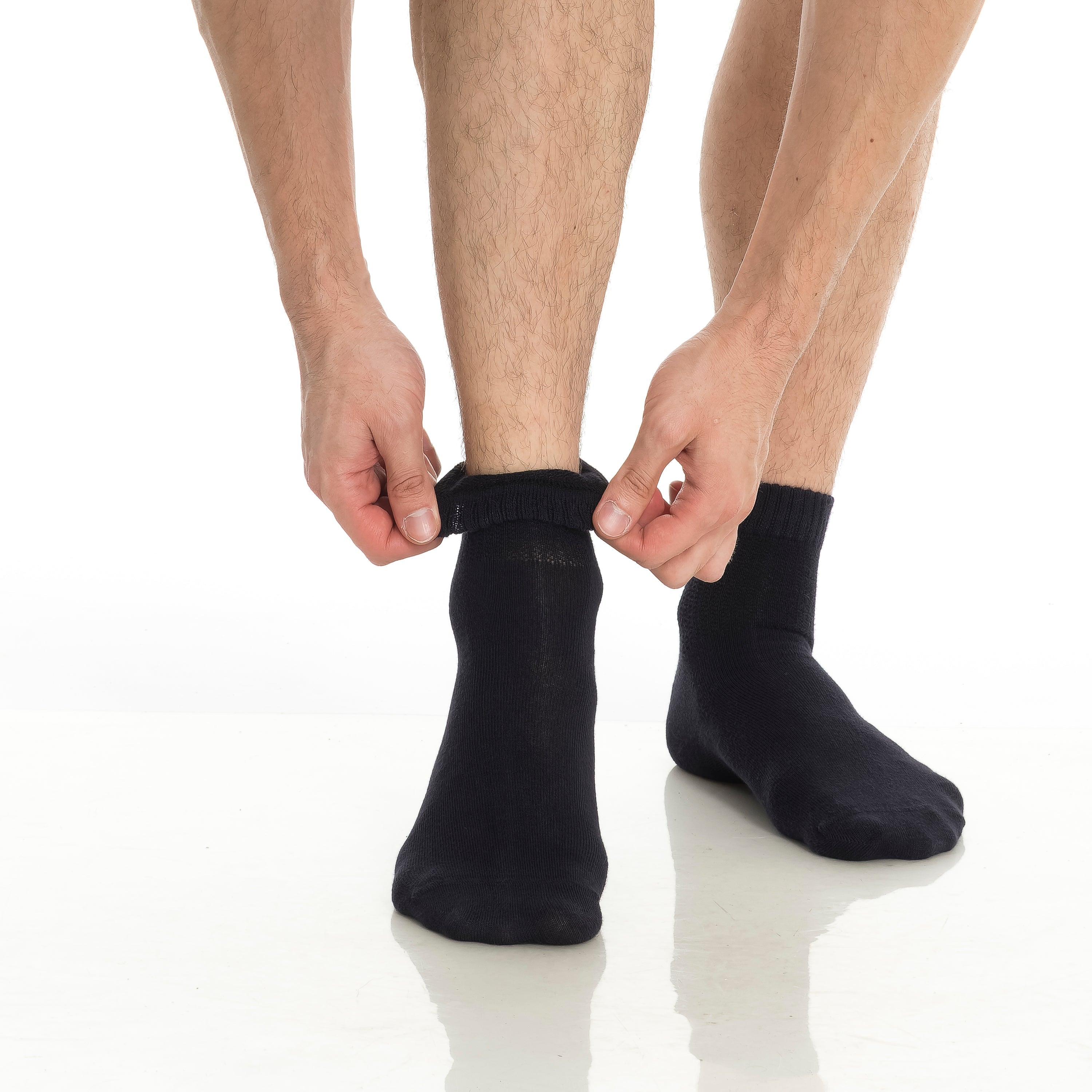 Bamboo diabetic ankle socks 4-pack, black socks being pulled on at the ankle