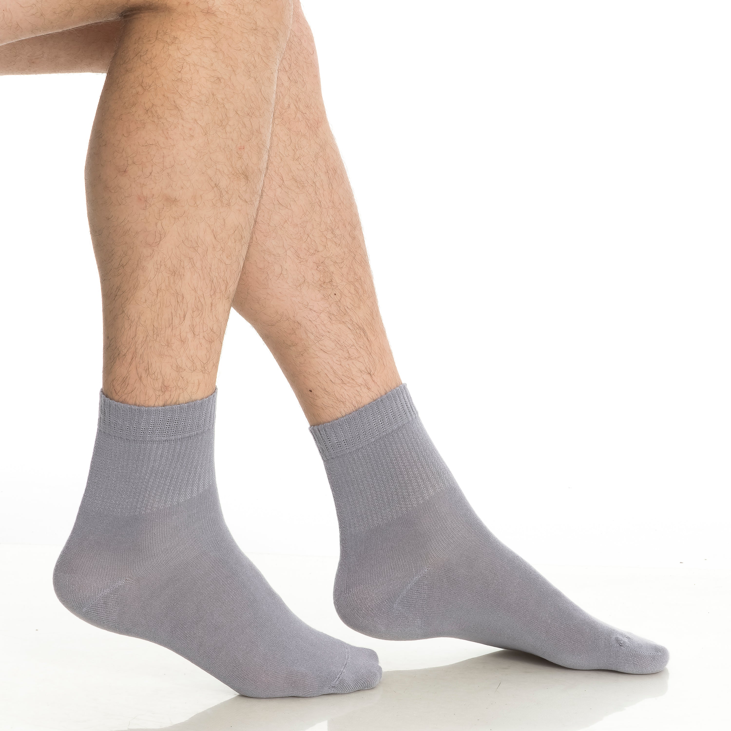Gray bamboo diabetic ankle socks on feet, smooth toe and crew cuff.