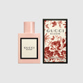 Light pink eau de parfum bottle with Gucci Bloom label and floral gift box, red