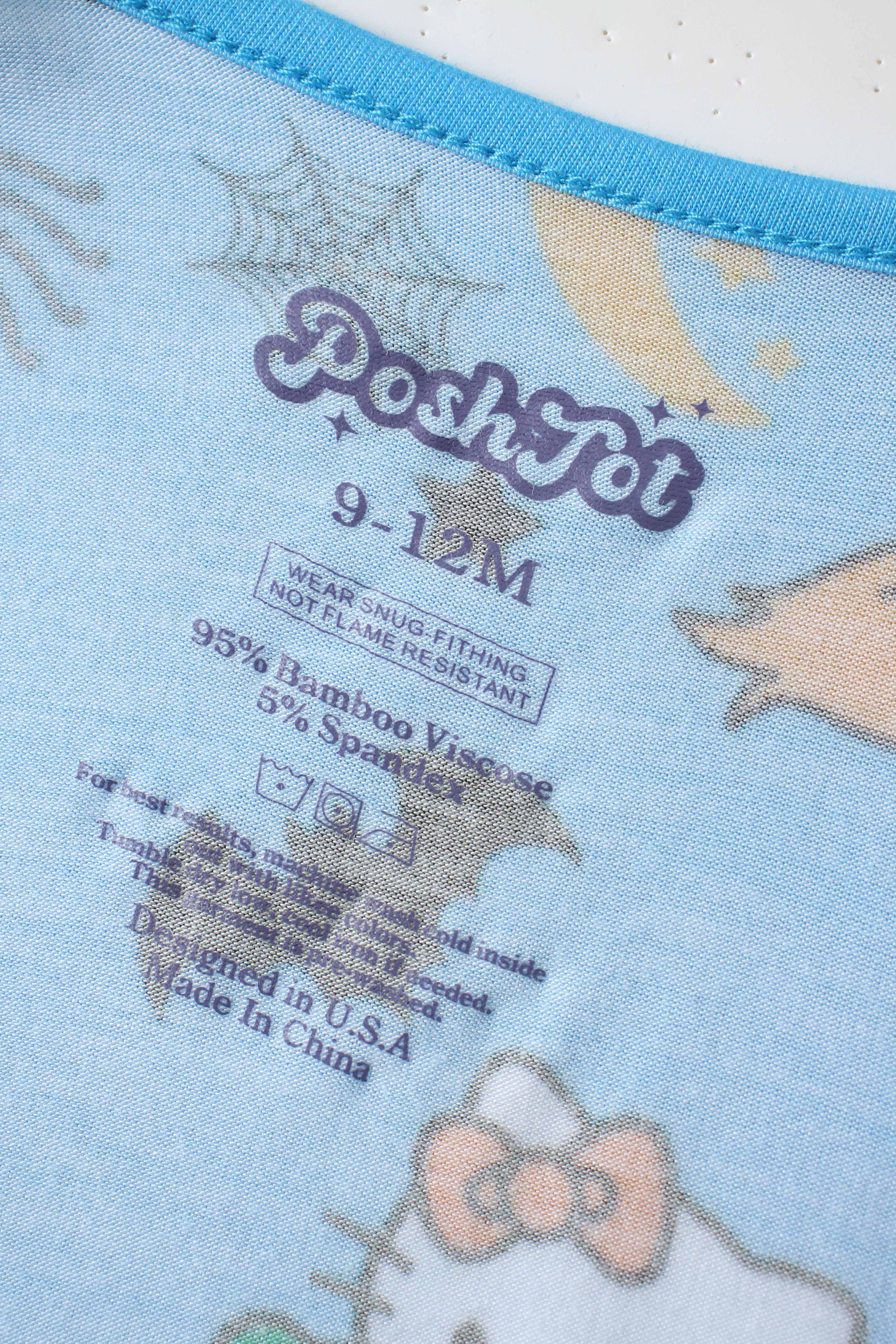 PoshTOT inner neck label on blue baby bamboo romper with stars and cat print
