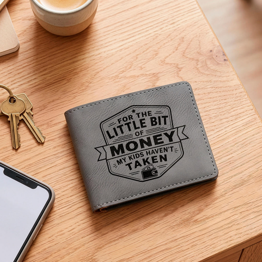 Gray leather slim bifold wallet on wood table with engraved money design