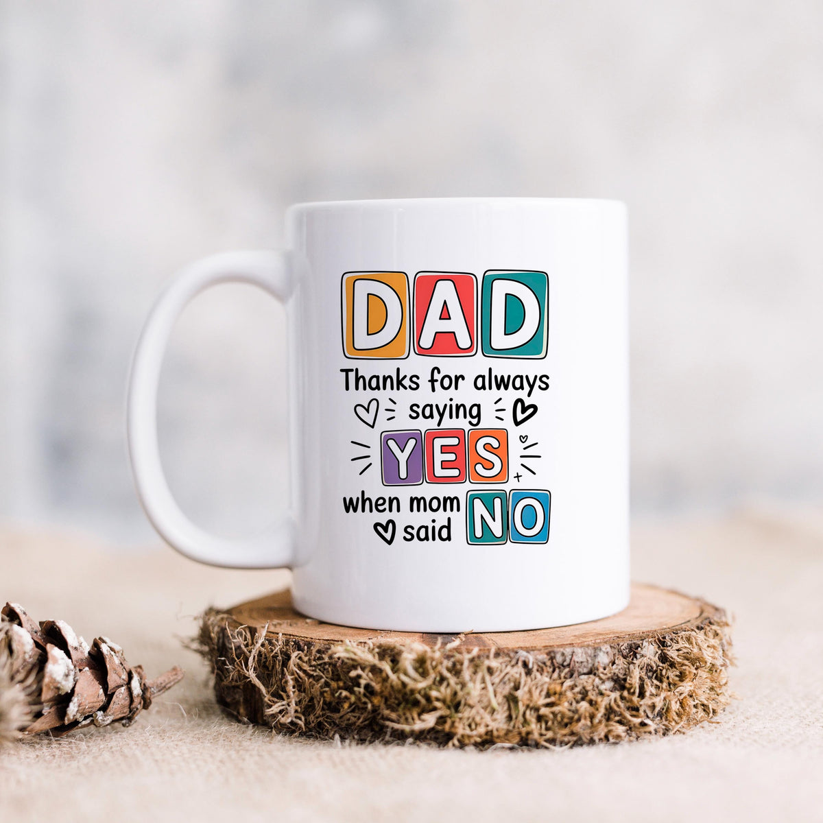 White ceramic mug with “DAD” lettering and “YES” and “NO” joke message