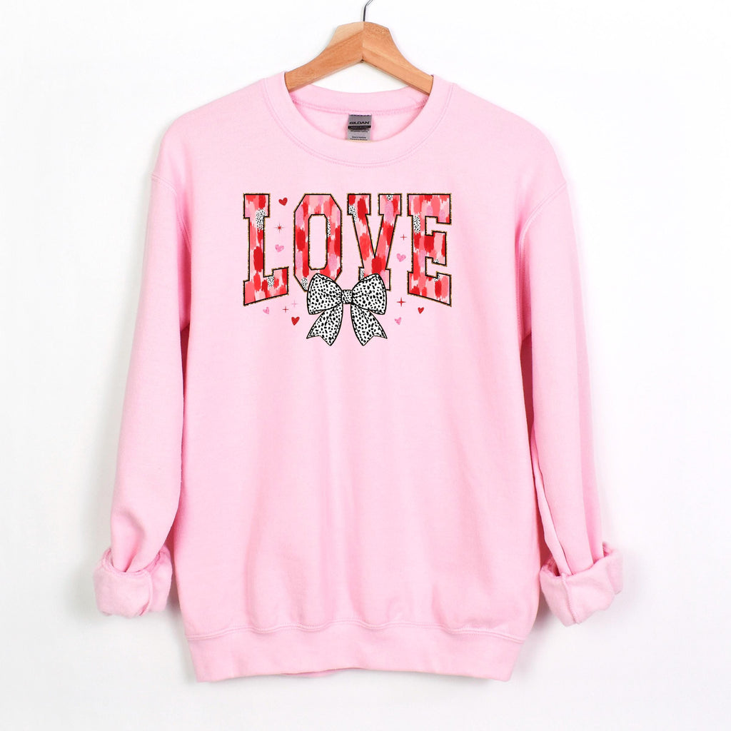 Light pink crewneck sweatshirt with LOVE graphic and black polka-dot bow