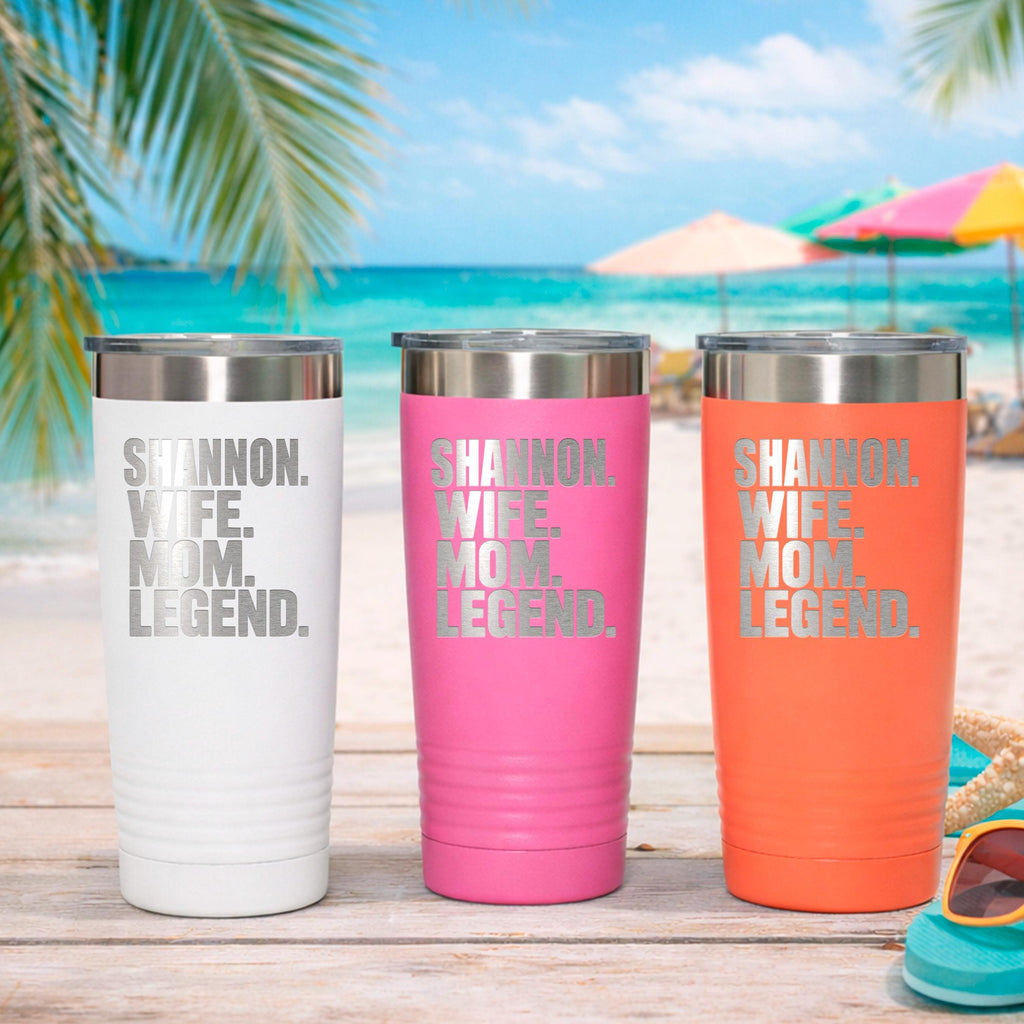 Personalized stainless steel tumblers, white, pink, and orange with “Shannon Wife Mom Legend.”