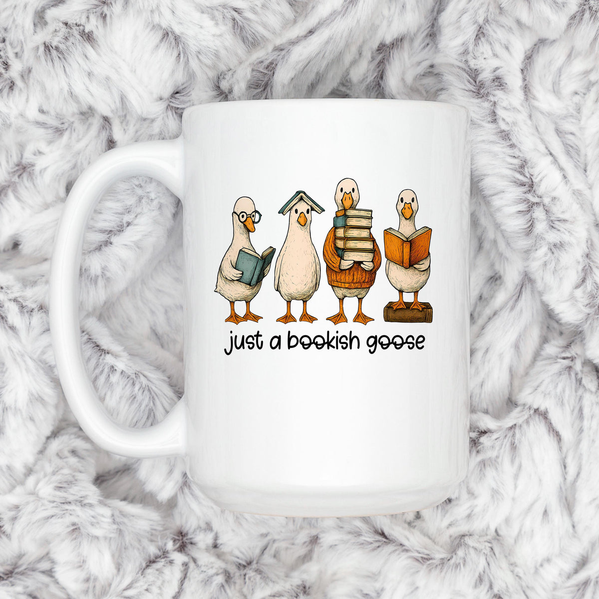 White ceramic mug with bookish goose graphic and "just a bookish goose" on the front