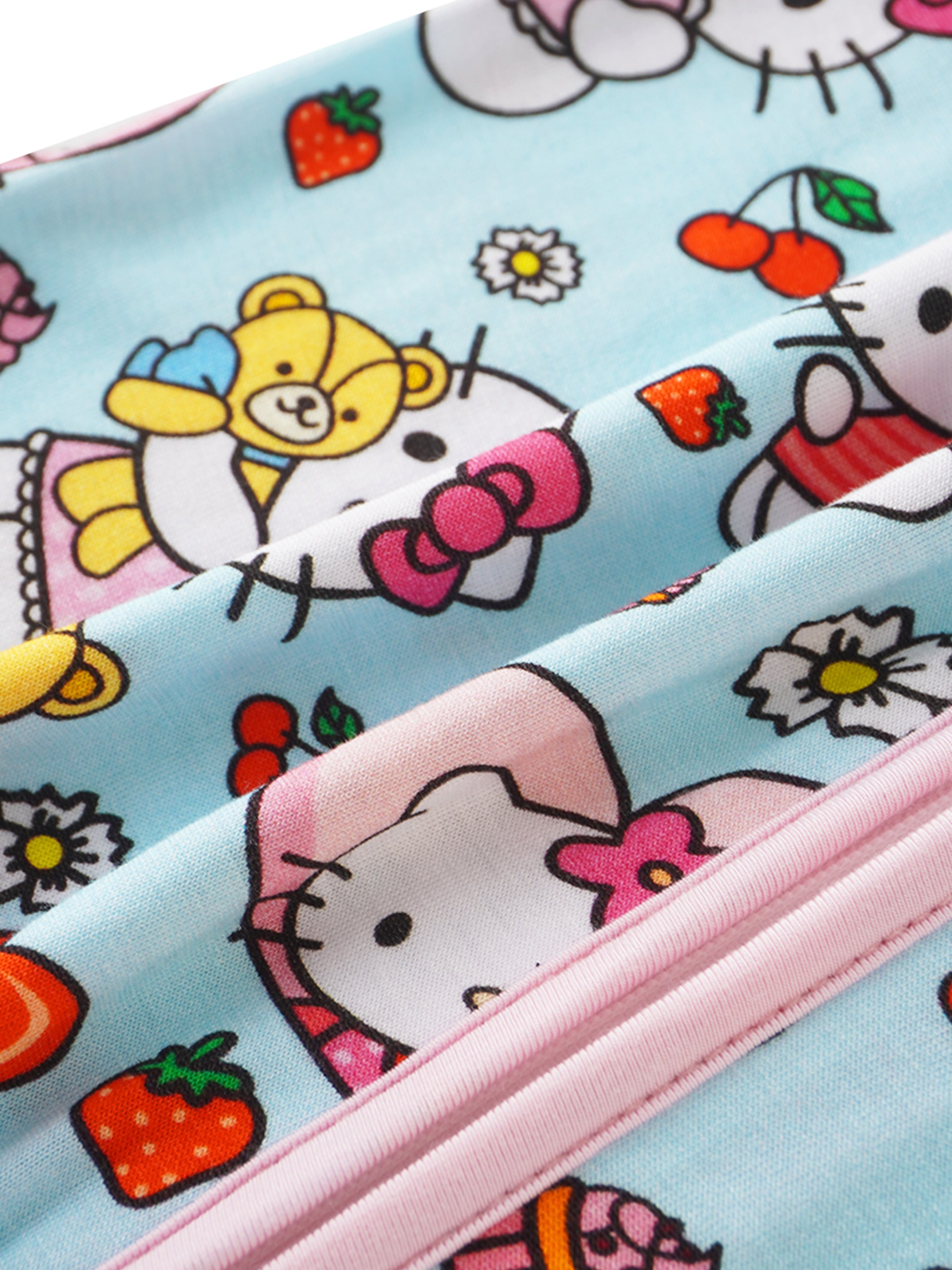 Bamboo baby romper fabric detail with Hello Kitty friends and small fruit icons