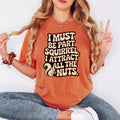Rust orange relaxed-fit T-shirt with bold squirrel quote graphic on the front