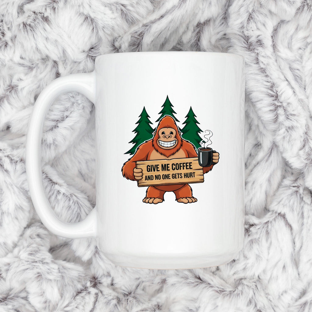 White ceramic coffee mug featuring Bigfoot holding a quote sign and steaming cup.