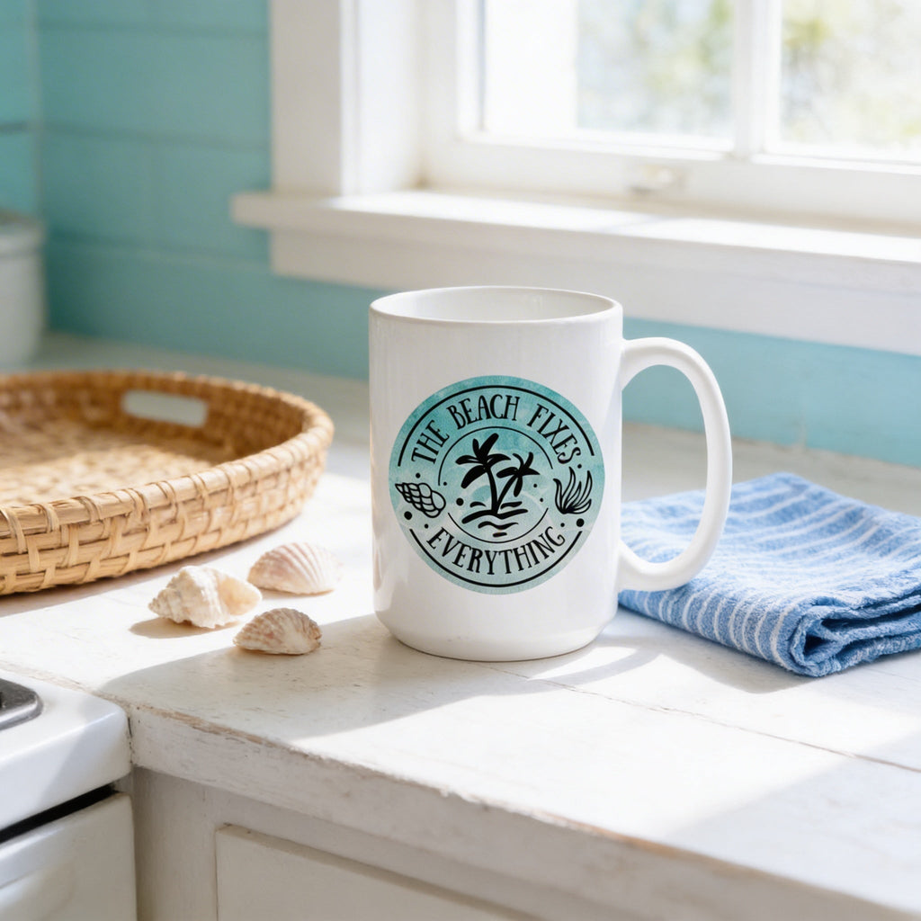 White ceramic coffee mug with teal beach “The Beach Fixes Everything” seal