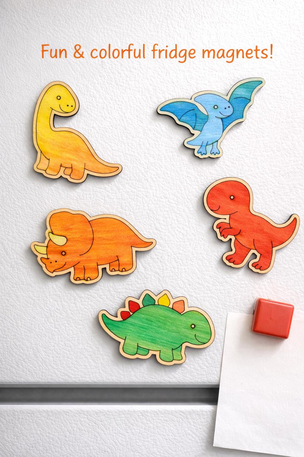 Colorful wooden dinosaur fridge magnets arranged on a light background