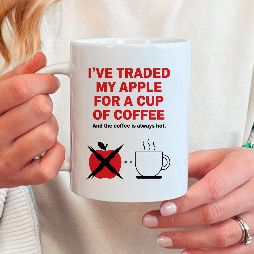 White ceramic mug with red coffee slogan held by hands, crossed apple icon