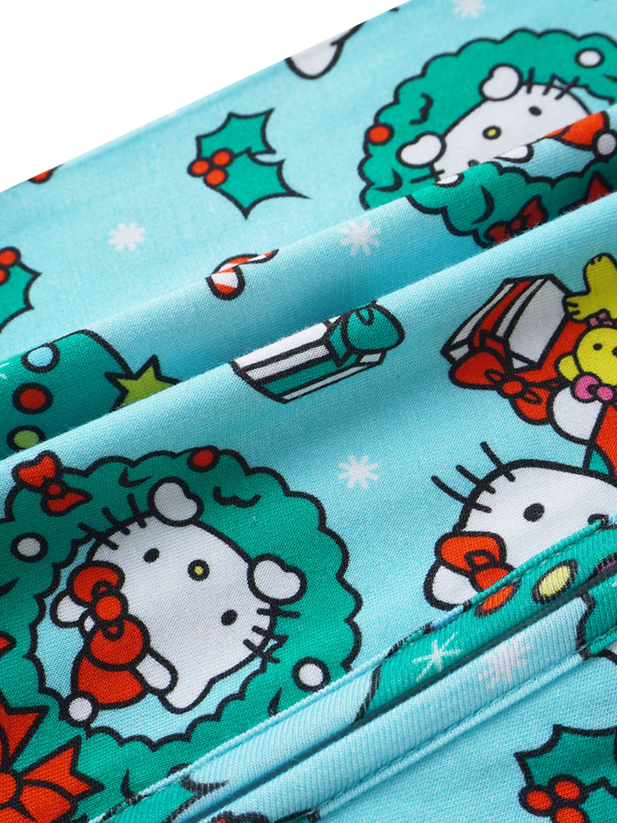 Baby romper fabric close-up in light blue with Christmas wreath and Hello Kitty faces