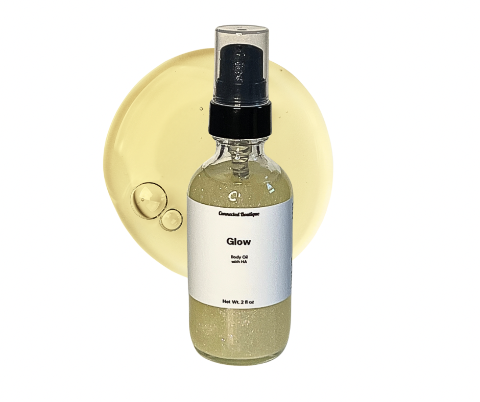Glow body oil spray bottle, clear glass with black pump, olive-gold oil liquid