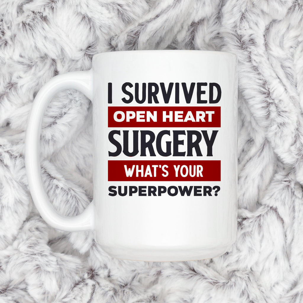 White coffee mug on plush fabric featuring: I Survived Open Heart Surgery, What’s Your Superpower?