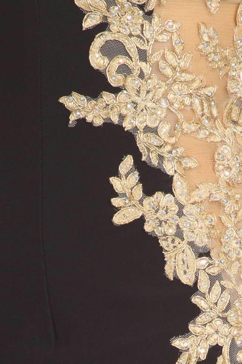 Close-up of gold lace applique on a dark short cocktail dress