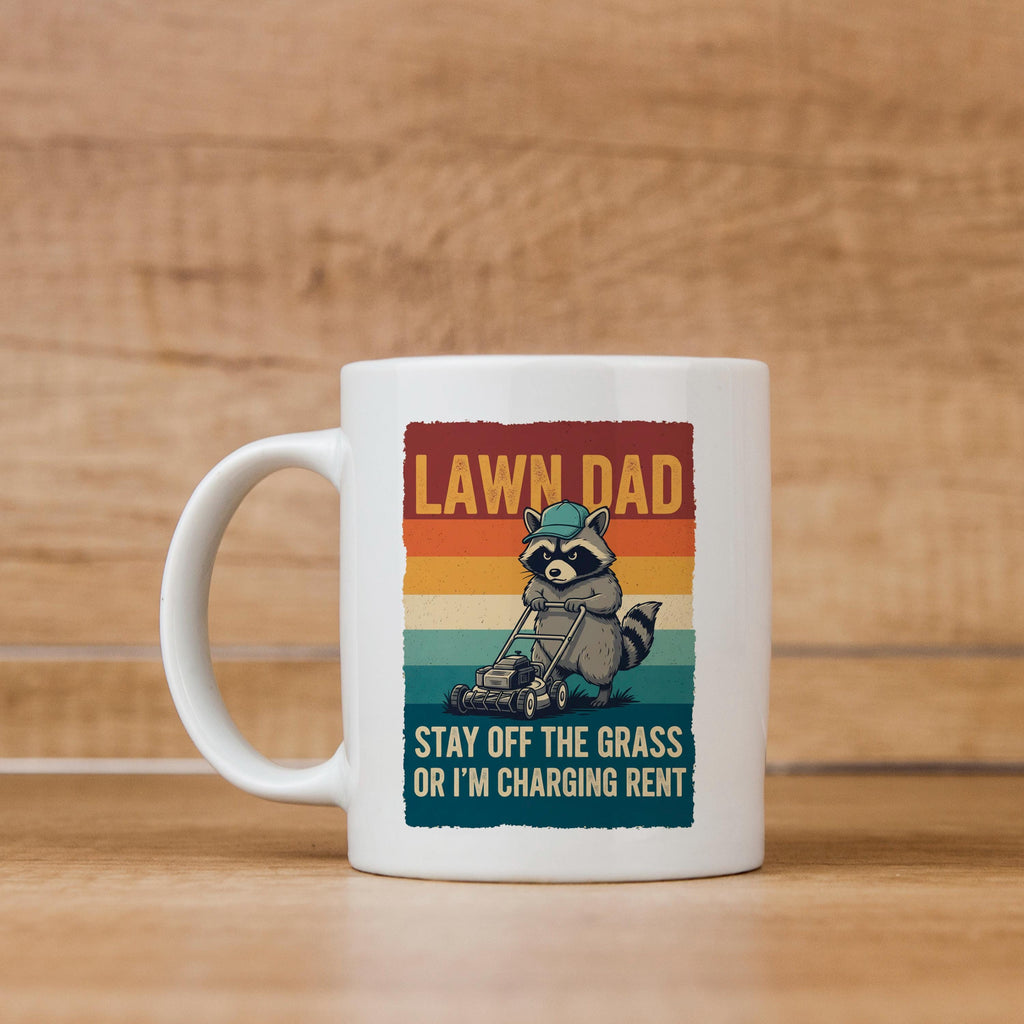 White coffee mug with raccoon mowing graphic and “LAWN DAD” text on front