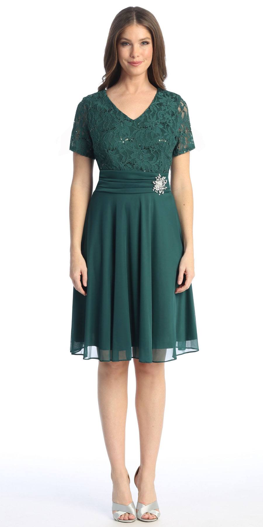 Teal knee-length dress with short sleeves, V-neck, and beaded waist detail